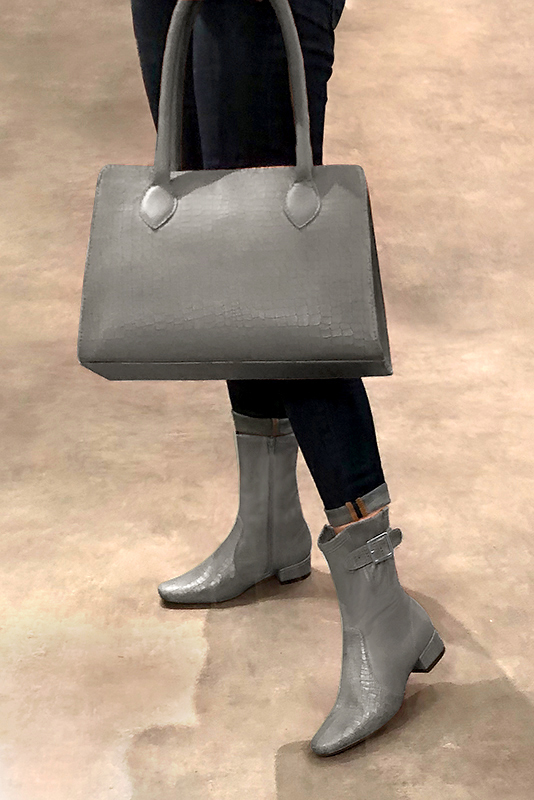 Women's ash grey elegant ankle boots, with buckles on the sides. Round toe. Low block heels - Worn view